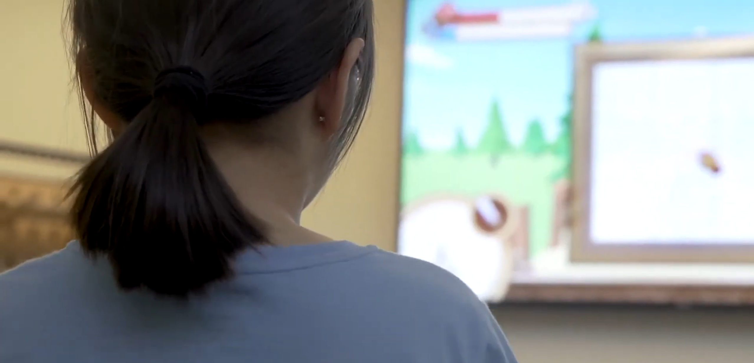 Child playing the Magic Word Adventure motion-sensing literacy game